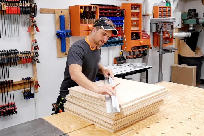 man building with wood in a workshop