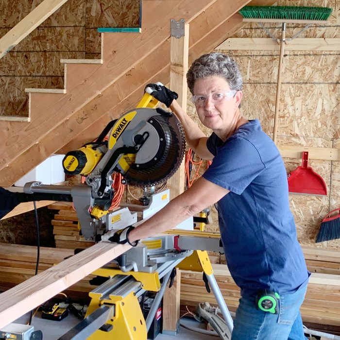 Mary Kehl using a saw in a workshop