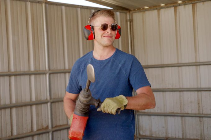 Luke Barr with a power tool building a pet palace